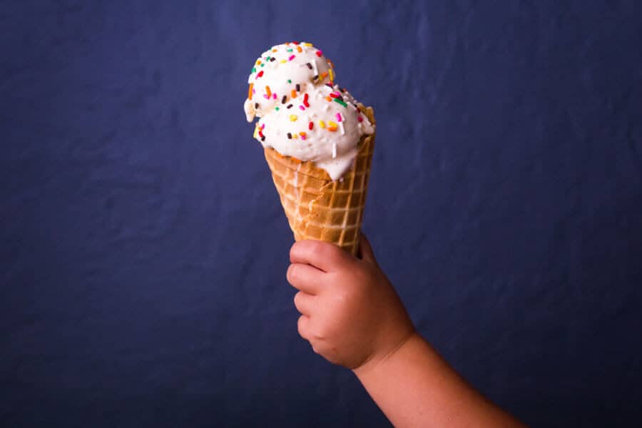 Helado sostenido por la mano de un niño